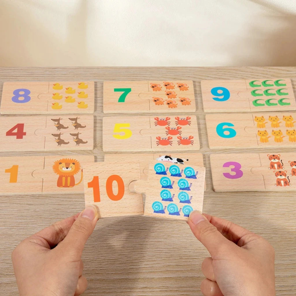 Full Montessori number matching puzzle setup with open box, animal-themed and dot-matching wooden pieces neatly arranged on table.