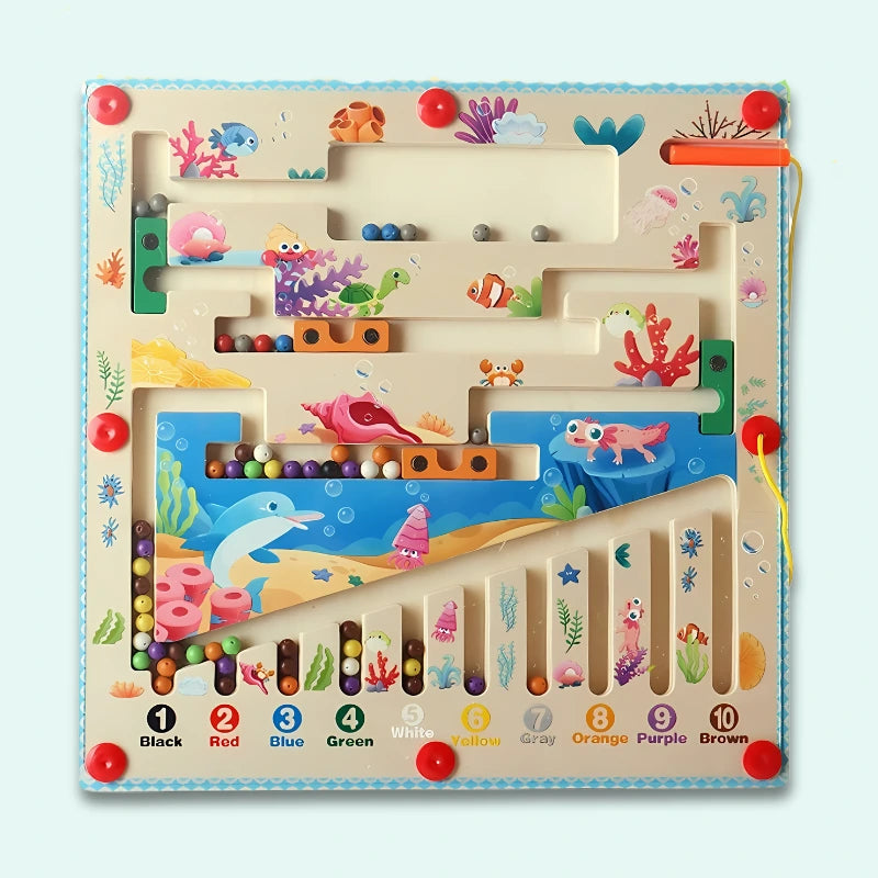 Ocean-themed Magnetic Maze featuring colorful marine life, coral reefs, fish, dolphins, and underwater scenery, with ten color-coded numbered channels for progressive learning play.